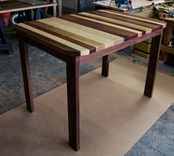 Pierson Table - Tabletop made with walnut, poplar, mahogany and optional round corners on walnut base