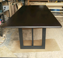 Burke Table - Bronze walnut finish table top with bullnose edges on black base