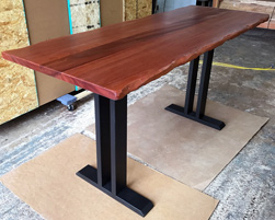 Bandera Table - Small mahogany table with optional live edge cut and black trestle base for booth seating