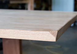 Aurora Table - Bevel cut at the corners on a red oak table top
