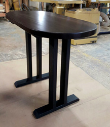 Springfield Table - Small oval table finished with bronze walnut on black trestle base