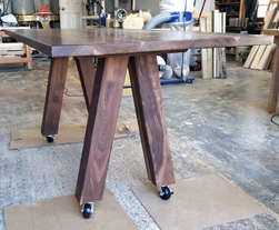 Victoria Table - Walnut table top with custom 4x4 V base with locked casters for a restaurant