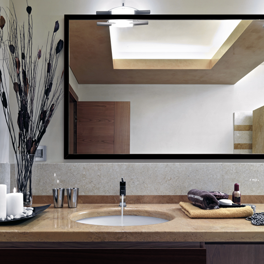 Wide large mirror with black frame in bathroom